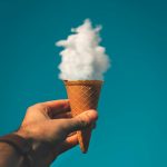 man holding ice cream cone under cloud